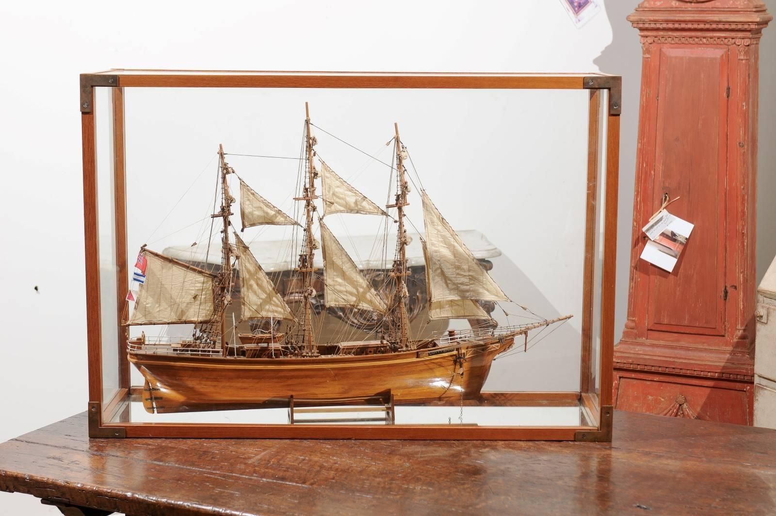 A model of the 1869 English sail powered ship Cutty Sark in a display case. This late 19th century finely detailed model of the Cutty Sark sits in a display case that showcases the extraordinary work of art the ship was. One of the last - and