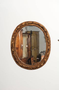 French Louis XIV Period 1710s Giltwood Oval Mirror with Carved Rosettes