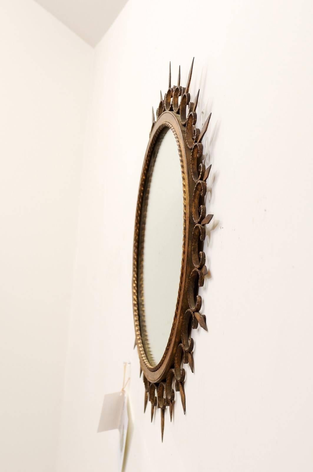 20th Century French Gilded Forged Iron Sunburst Mirror with Stylized Fleurs-de-Lys Motifs