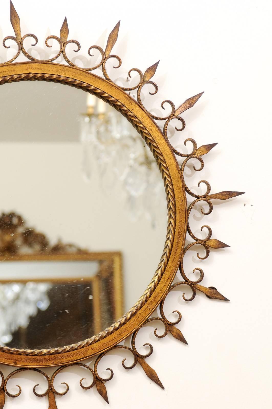 Mid-Century Modern French Gilded Forged Iron Sunburst Mirror with Stylized Fleurs-de-Lys Motifs