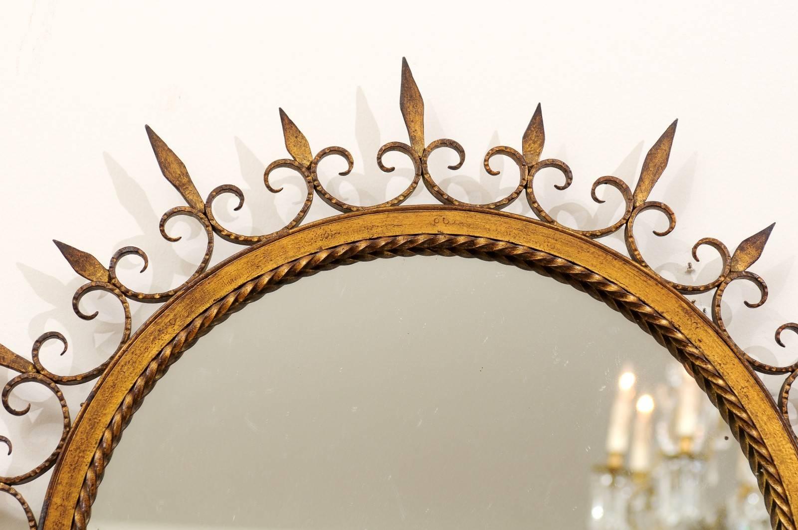 French Gilded Forged Iron Sunburst Mirror with Stylized Fleurs-de-Lys Motifs In Good Condition In Atlanta, GA
