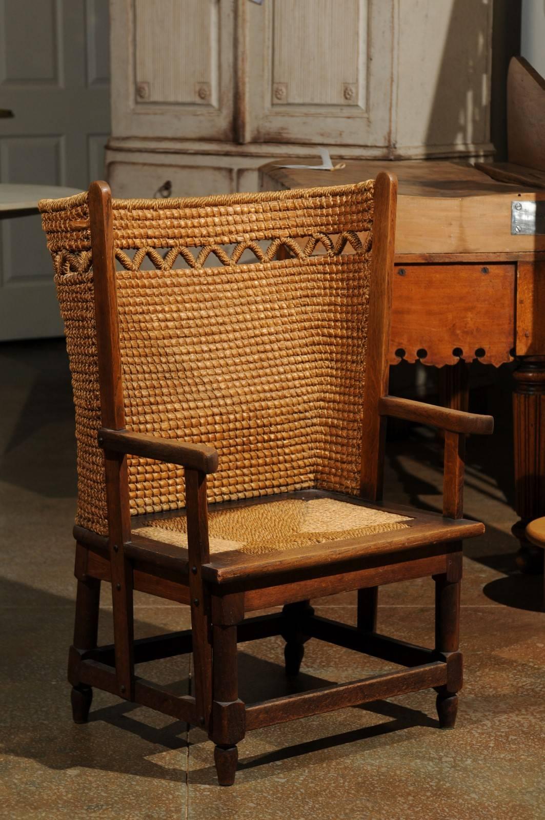 An authentic 19th century Orkney chair with zigzag-patterned handwoven straw back from the Island of Orkney near the Northern tip of Scotland. This armchair features a wooden armature supporting a curved back, reminiscent of wingback chairs,