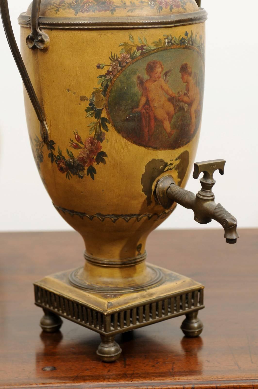 A French, 19th century painted tole coffee pot with cherub décor, scrolled handles and finial covered lid. This French painted tole coffee pot features a tall floral painted lid, topped with an urn-shaped finial. Two large scrolled handles allow the