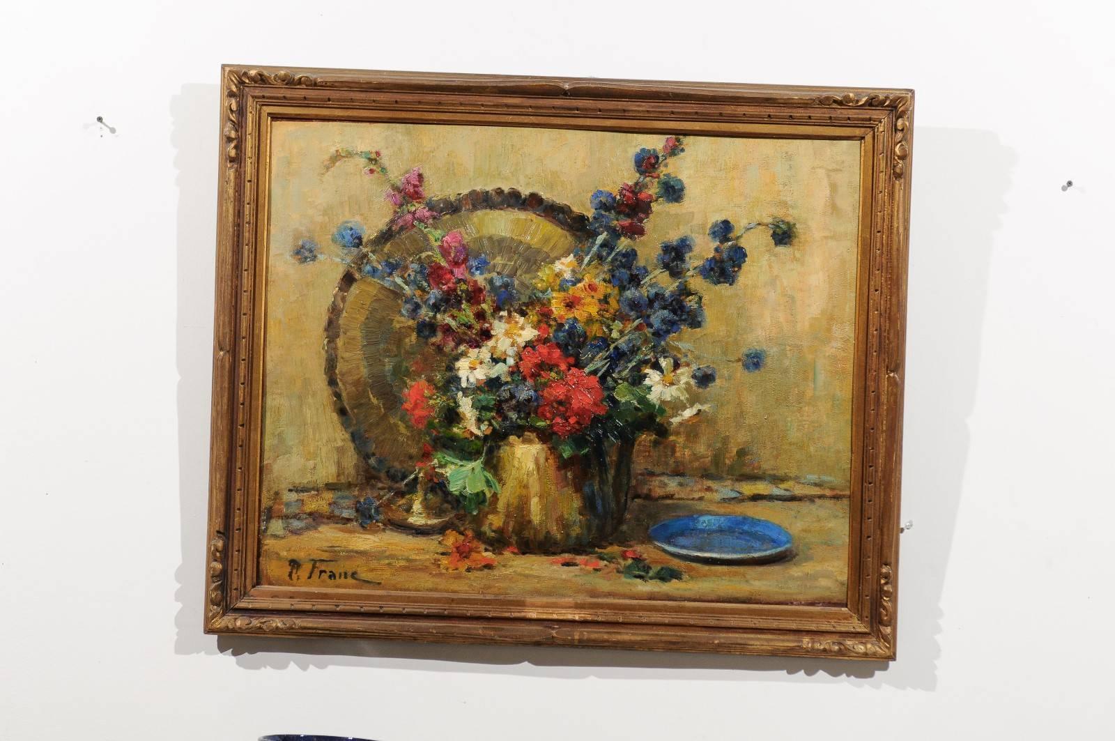 A French still life floral oil painting from the 19th century signed Pierre Franc inside a giltwood frame. This French painting features an exquisite floral still-life, made of a colorful bouquet of flowers set inside a copper looking pitcher. The