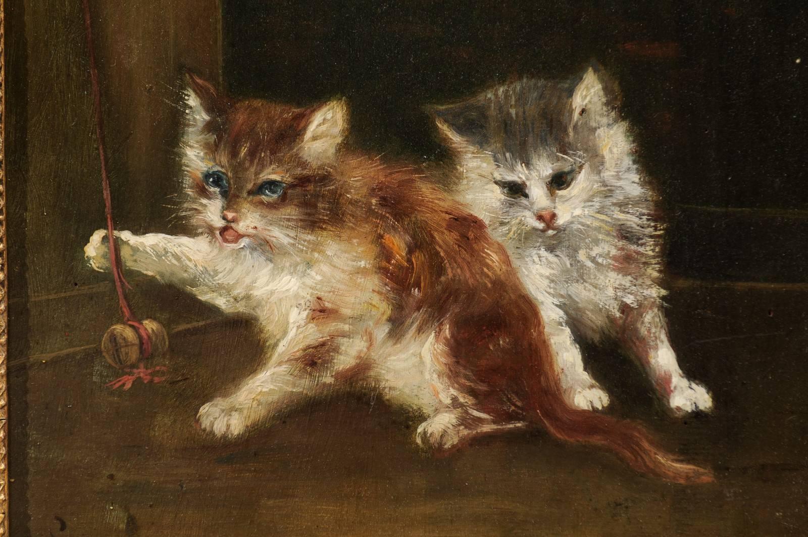 Peinture à l'huile sur toile française des années 1890 représentant des chatons jouant dans un cadre en bois doré 1