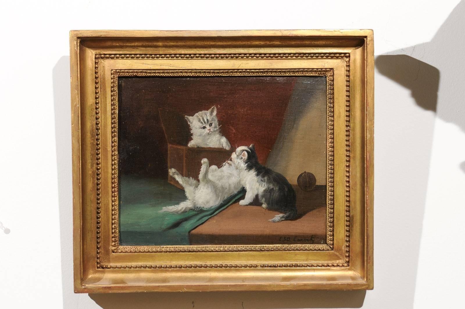 Late 19th century French oil on canvas painting of kittens playing signed Laroche in giltwood frame. This French oil on canvas painting features a lovely scene depicting three kittens, two white ones along with a grey and white one playing with each