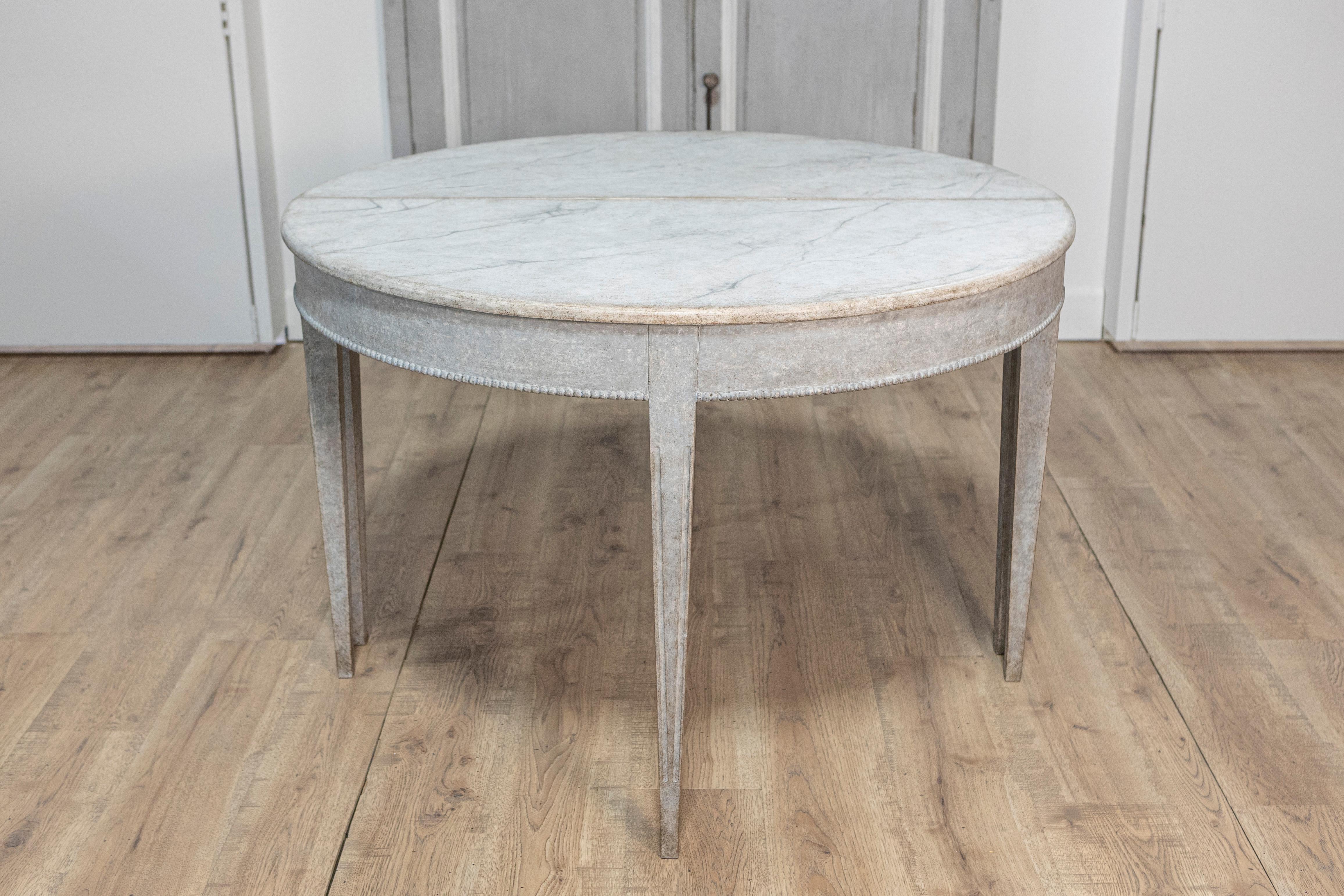 This exquisite 19th-century Swedish pair of demi-lune console tables, circa 1880, reflects the elegance and simplicity characteristic of Gustavian design.
Crafted from solid wood, this tables feature a classic half-moon shape with clean lines and a