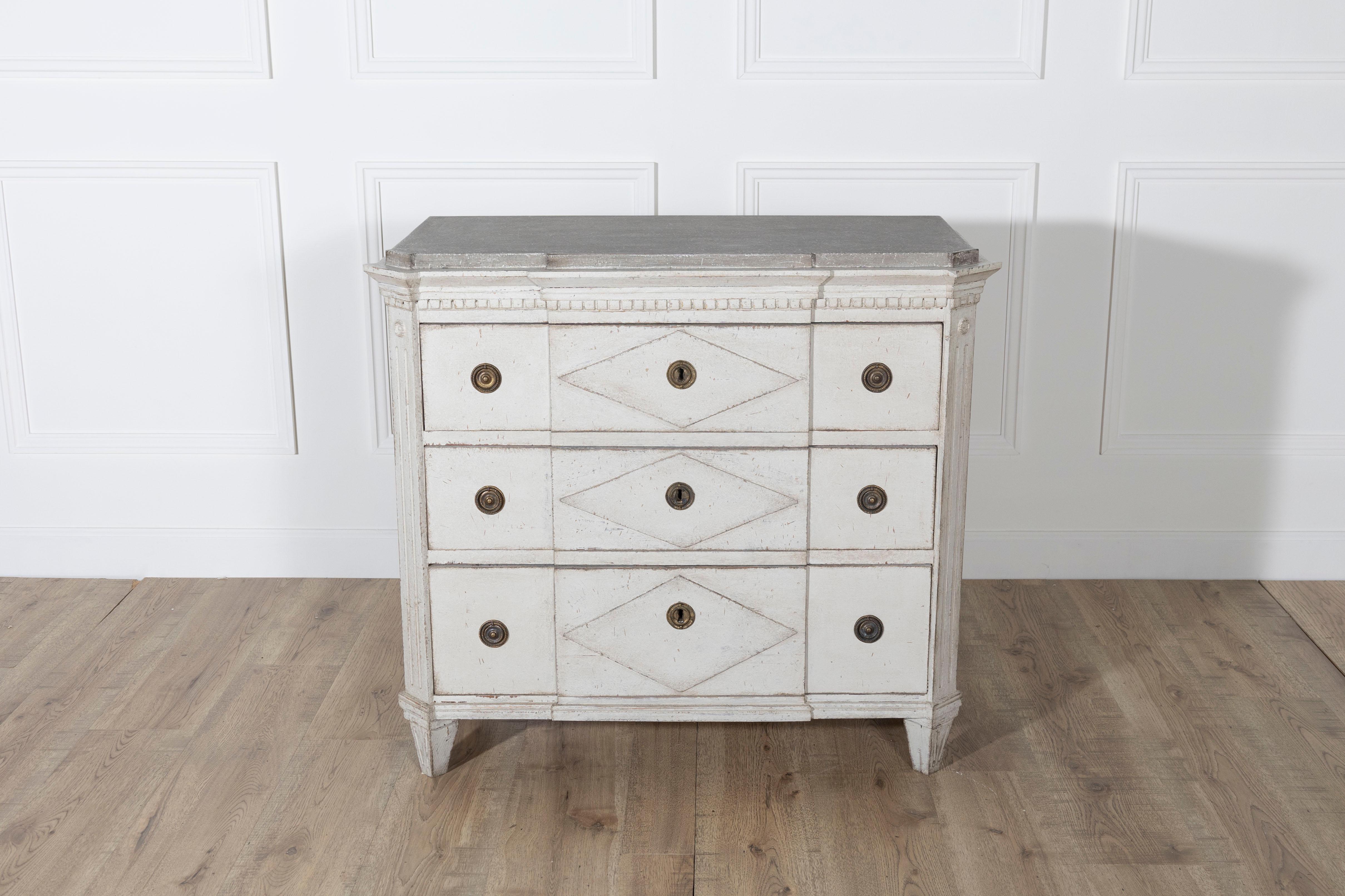 A beautifully detailed Swedish chest of drawers in the Gustavian style, dating to circa 1880. This elegant piece is painted in a soft sand tone with a lightly distressed patina, enhancing its neoclassical lines and timeless appeal. The chest stands
