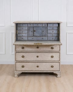 An antique Swedish bureau in antique white.