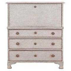 An antique Swedish bureau in antique white.