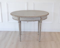 Oval table in the Gustavian style is finished in grey.