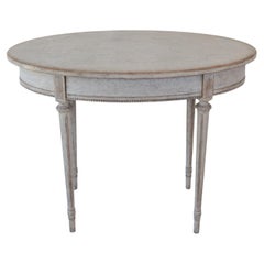 Oval table in the Gustavian style is finished in grey.