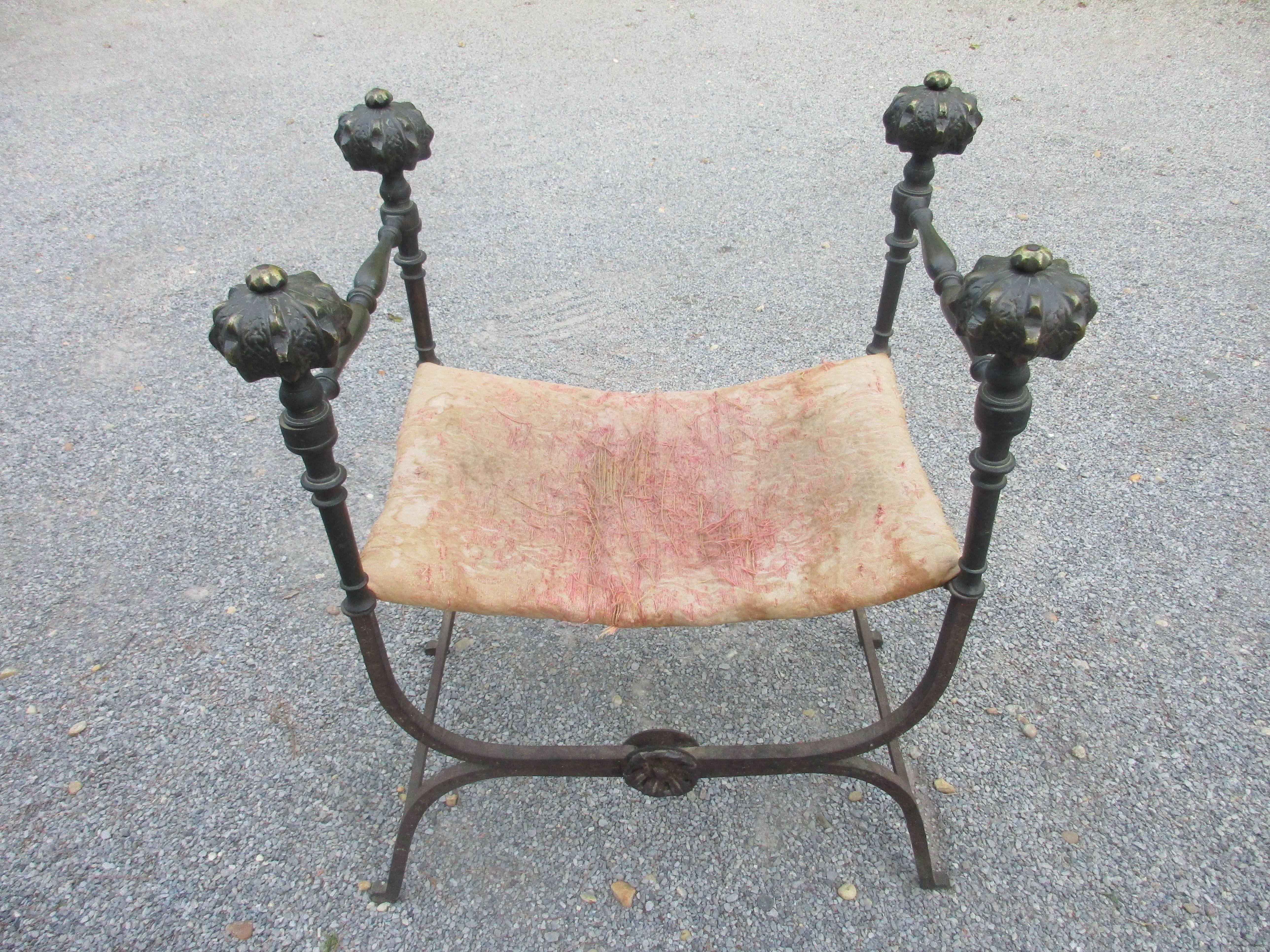 19th century Italian hand-forged iron and bronze folding stool with pink upholstered 
Seat great patina on bronze and iron.