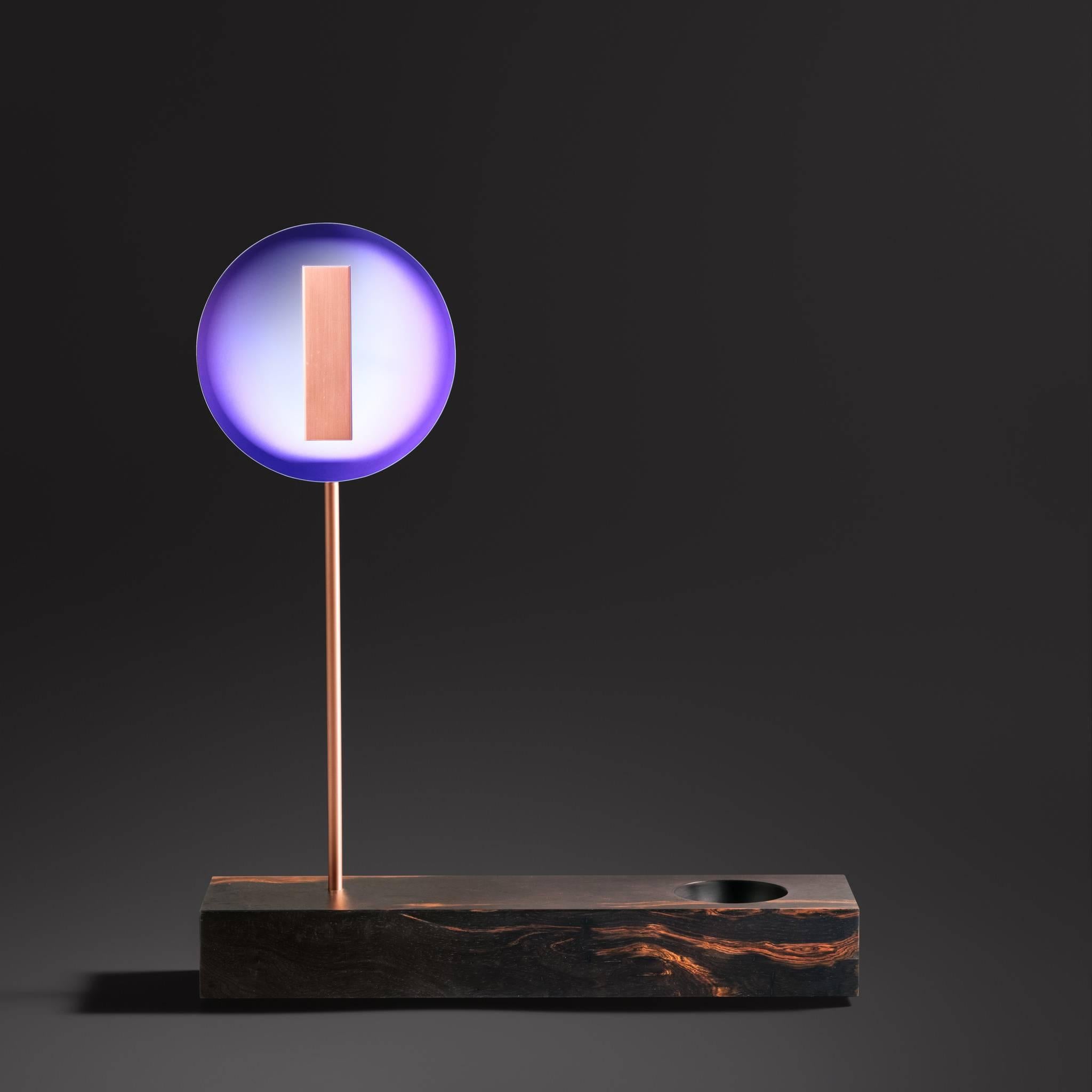 The flash lighting table lamp in purple niobium is part of the “Sintonia Fina” limited-edition series of table, floor and ceiling lamps. This piece is made with reclaimed wood, copper and niobium – a rare mineral, found in Brazil, used mainly in