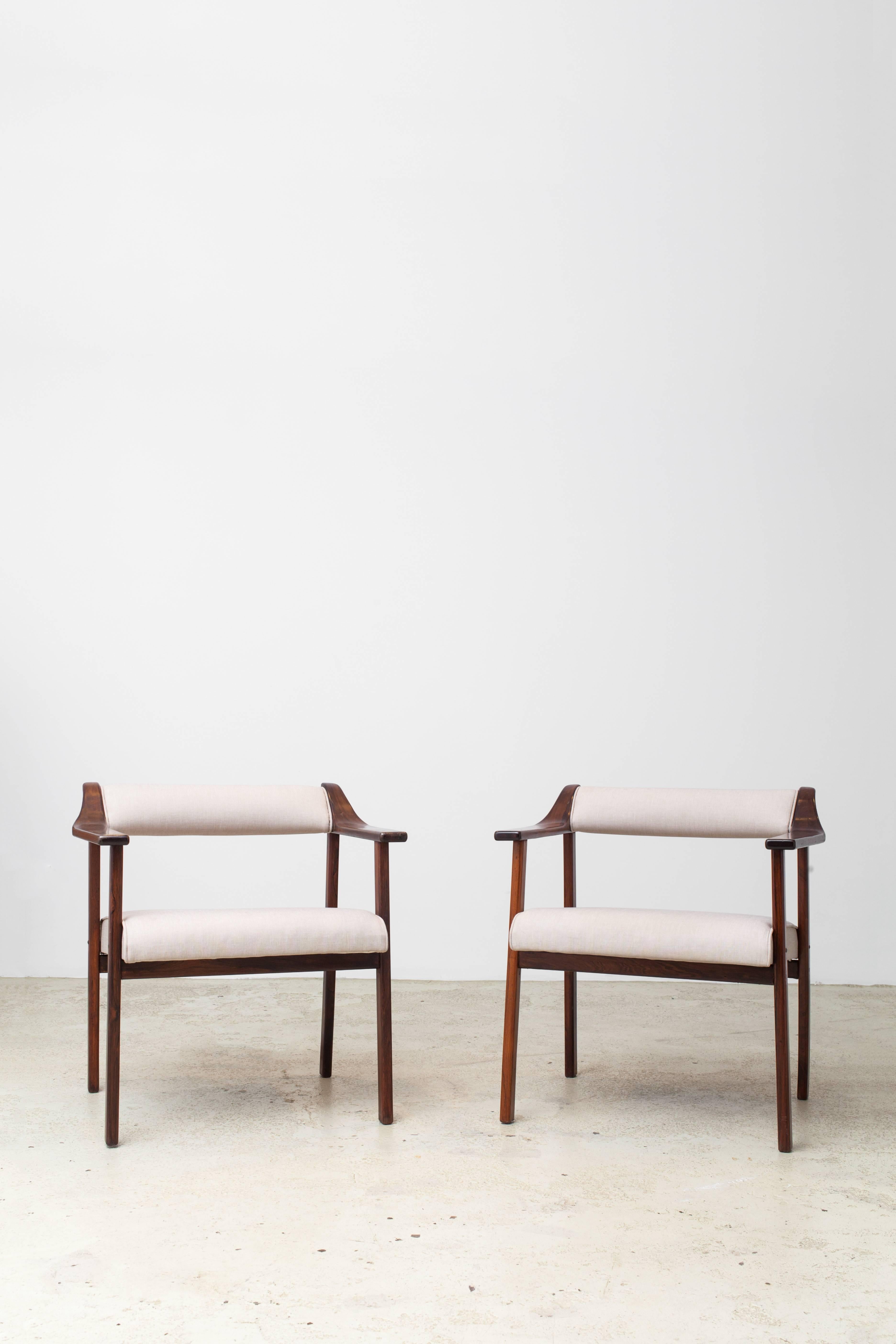 A pair of rare armchairs in solid jacaranda wood and fabric upholstery. Designed by Jean Gillon in 1968.