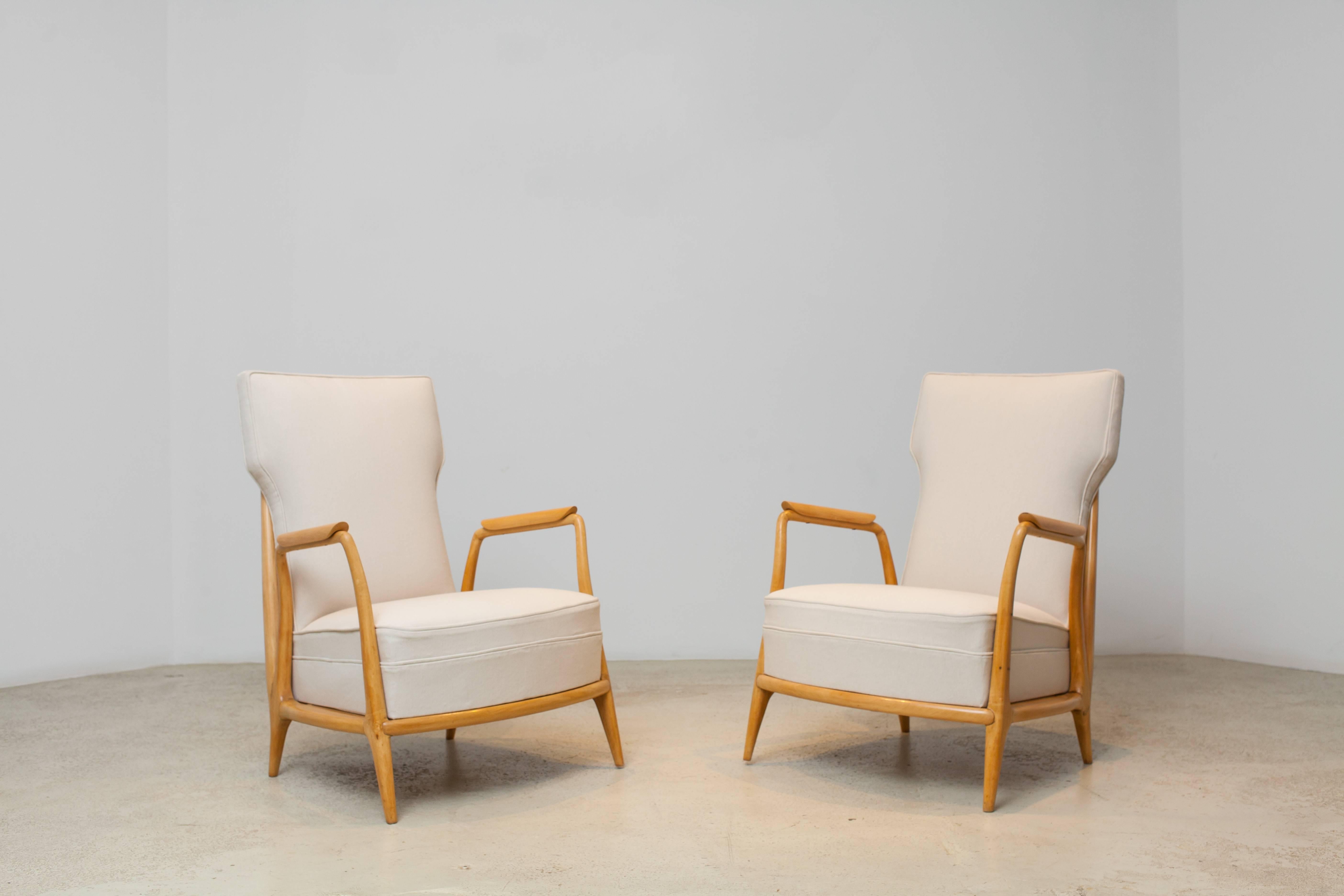 A rare pair of vintage low armchairs in solid Caviúna wood by Giuseppe Scappinelli.