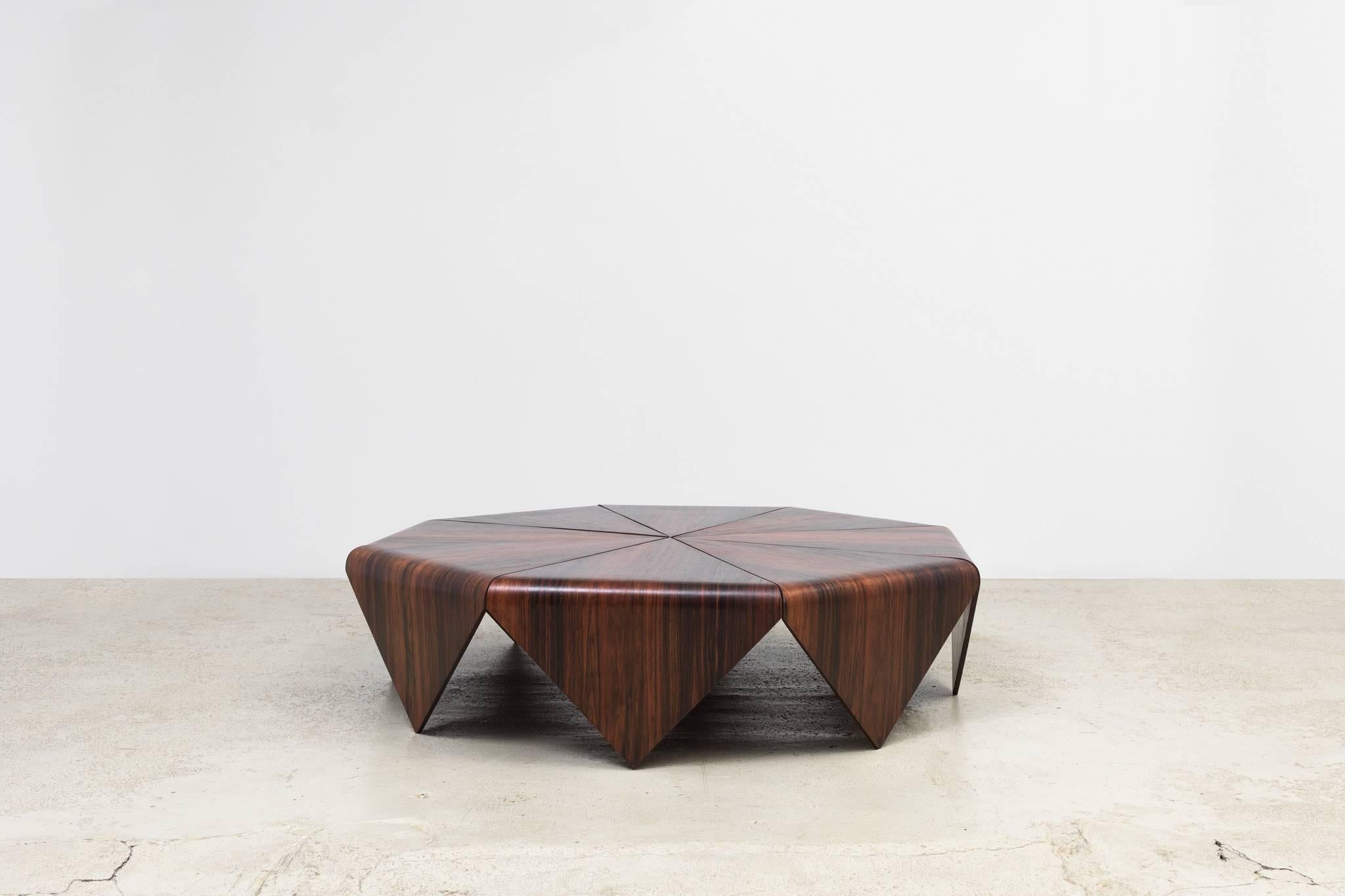 Vintage jacaranda wood coffee table designed by Brazilian designer Jorge Zalszupin in the 1960s. The folded paper structure of origami was the inspiration for the coffee table.

Zalszupin’s furniture designs are characterized by both geometric