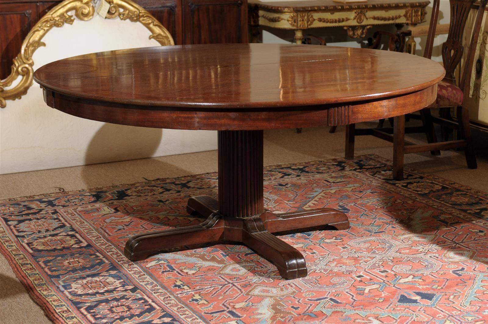 19th century Italian neoclassical style mahogany center dining table with pedestal base.
Optional two leaves (18