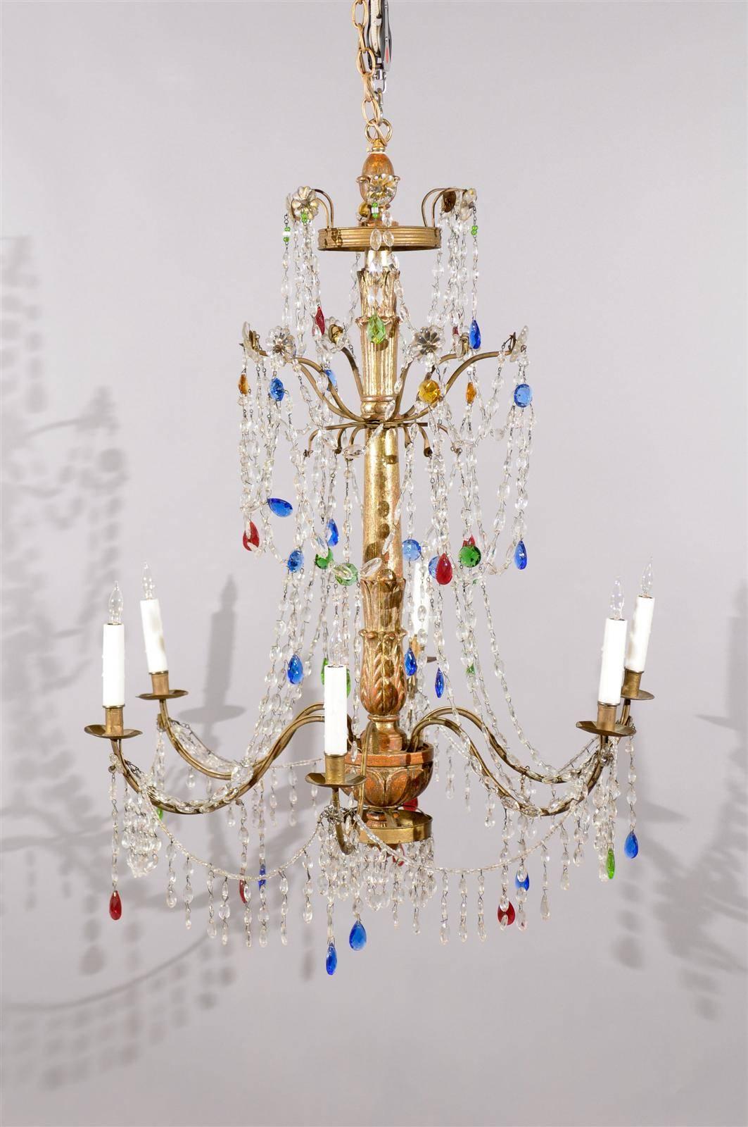 Italian neoclassical style giltwood and crystal chandelier with six lights and multicolored crystals.