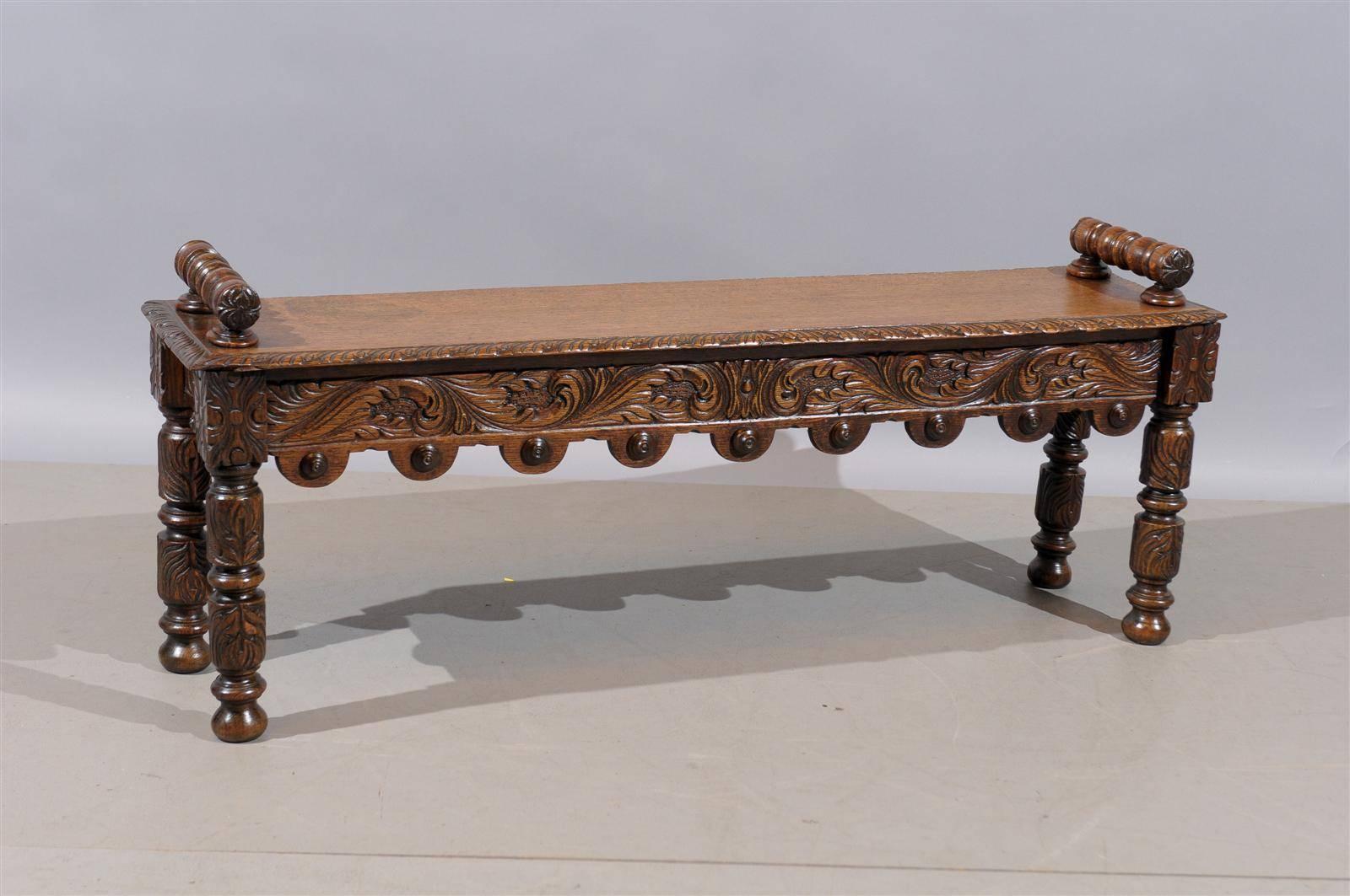 English oak hall bench with handles and carved decoration, circa 1890.