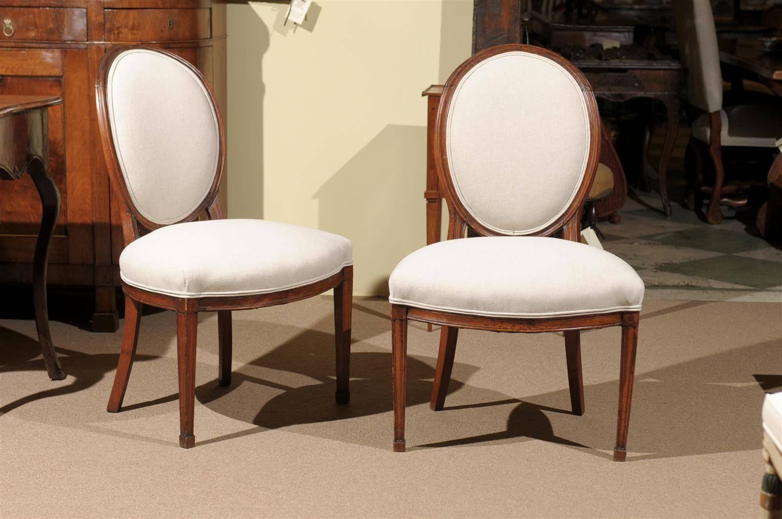 Pair of Louis XVI period balloon back side chairs in beechwood, France, circa 1780.