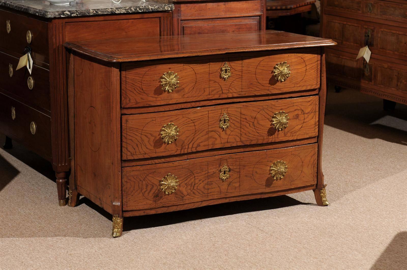 Unusual 18th century Swedish oak commode with inlaid designs and bronze doré hardware, serpentine front.