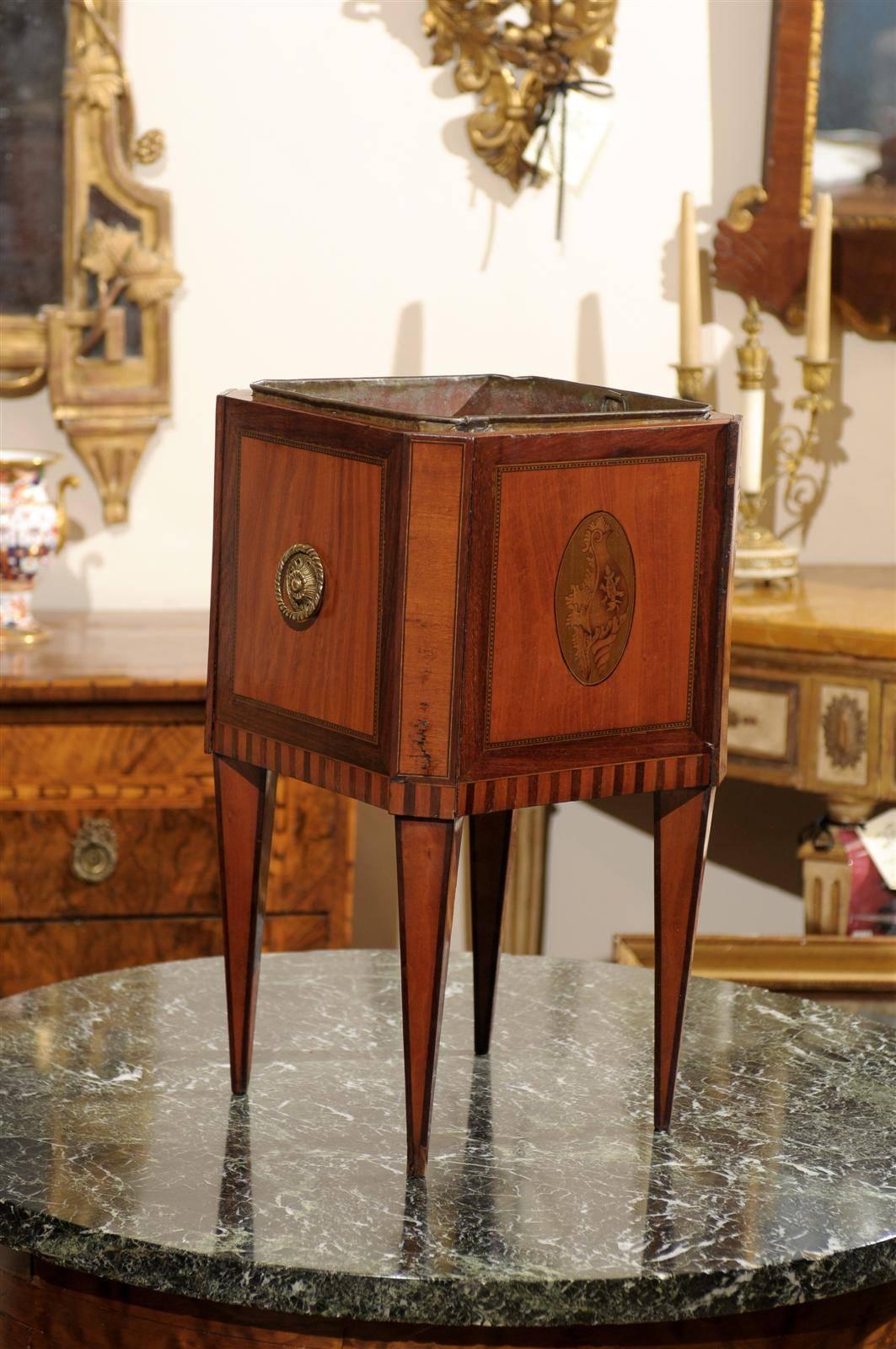 A Dutch walnut wine cooler/planter with liner featuring parquetry inlay, shell marquetry inlay and brass handles on sides ending on tapered legs.