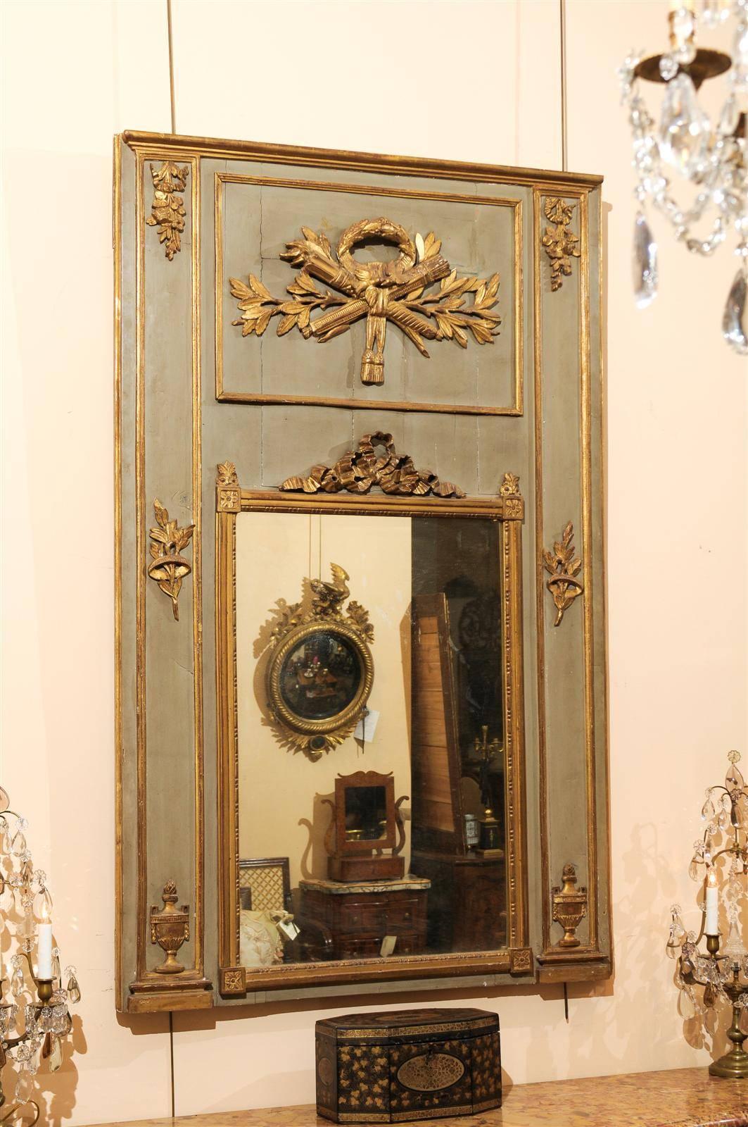 Louis XVI period painted and parcel-gilt trumeau mirror with neoclassical carvings.