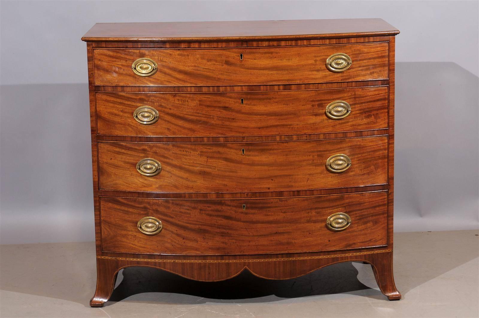 Early 19th century English Sheraton mahogany bowfront chest.