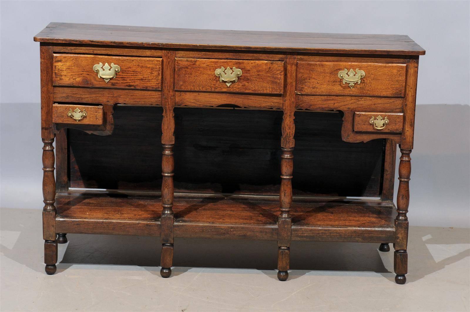 18th century English Jacobean style oak dresser base/server with lower shelf and five drawers.