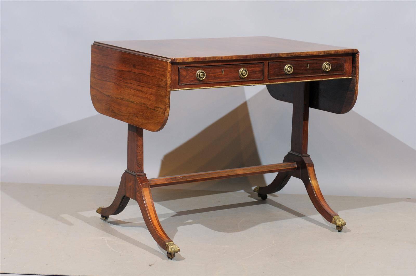 19th century Regency style drop leaf sofa table with gilt accent & brass paw feet, England.