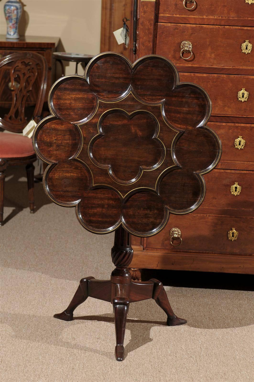 Manx rosewood tilt-top table with ten carved recesses (for tea service) and brass inlay, circa 1890.