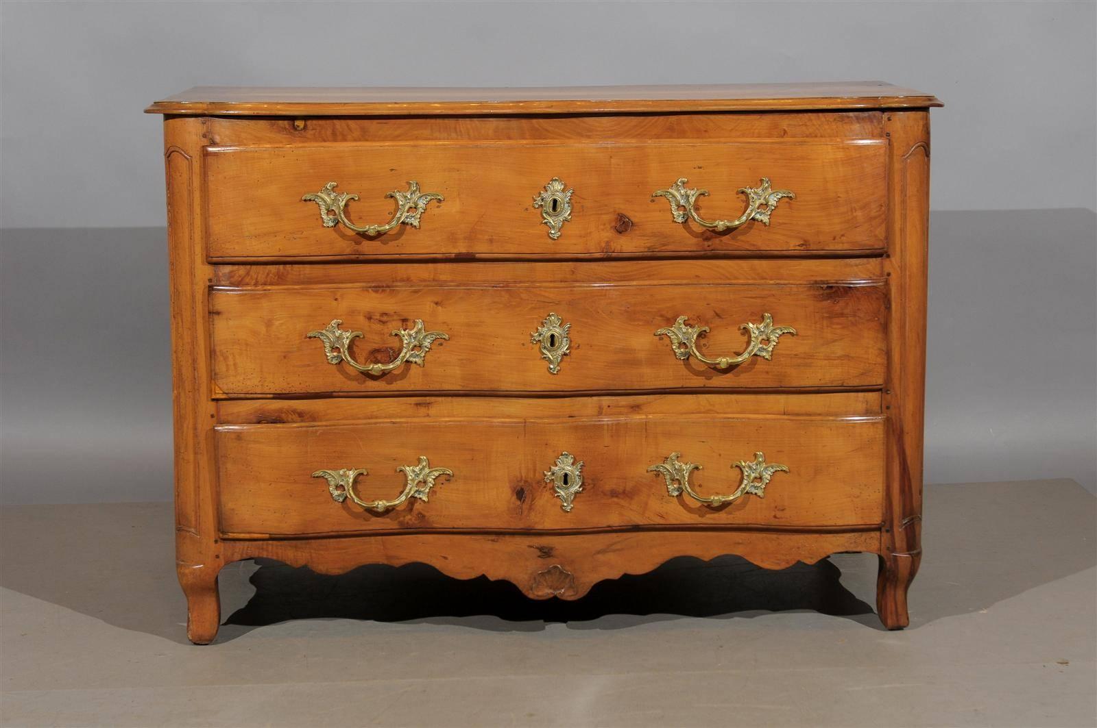 Early 19th century French fruitwood serpentine front commode with 3 drawers, paneled sides, and cabriole feet.