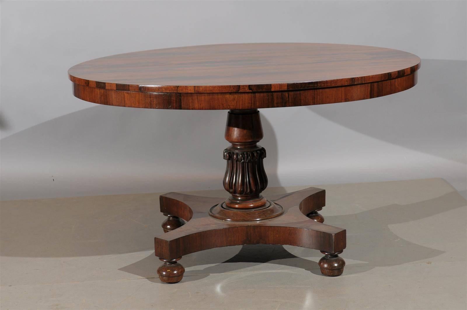 19th century English Regency rosewood center table with pedestal base and bun feet.
