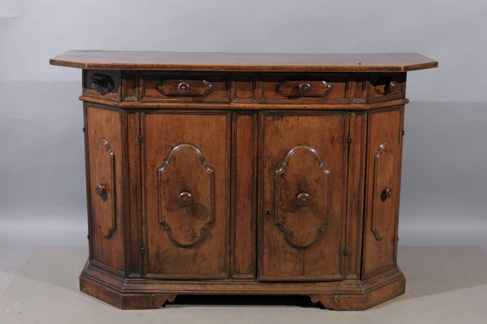 Large 17th century walnut credenza with four drawers and cabinet doors below with raised panels, Italy.
