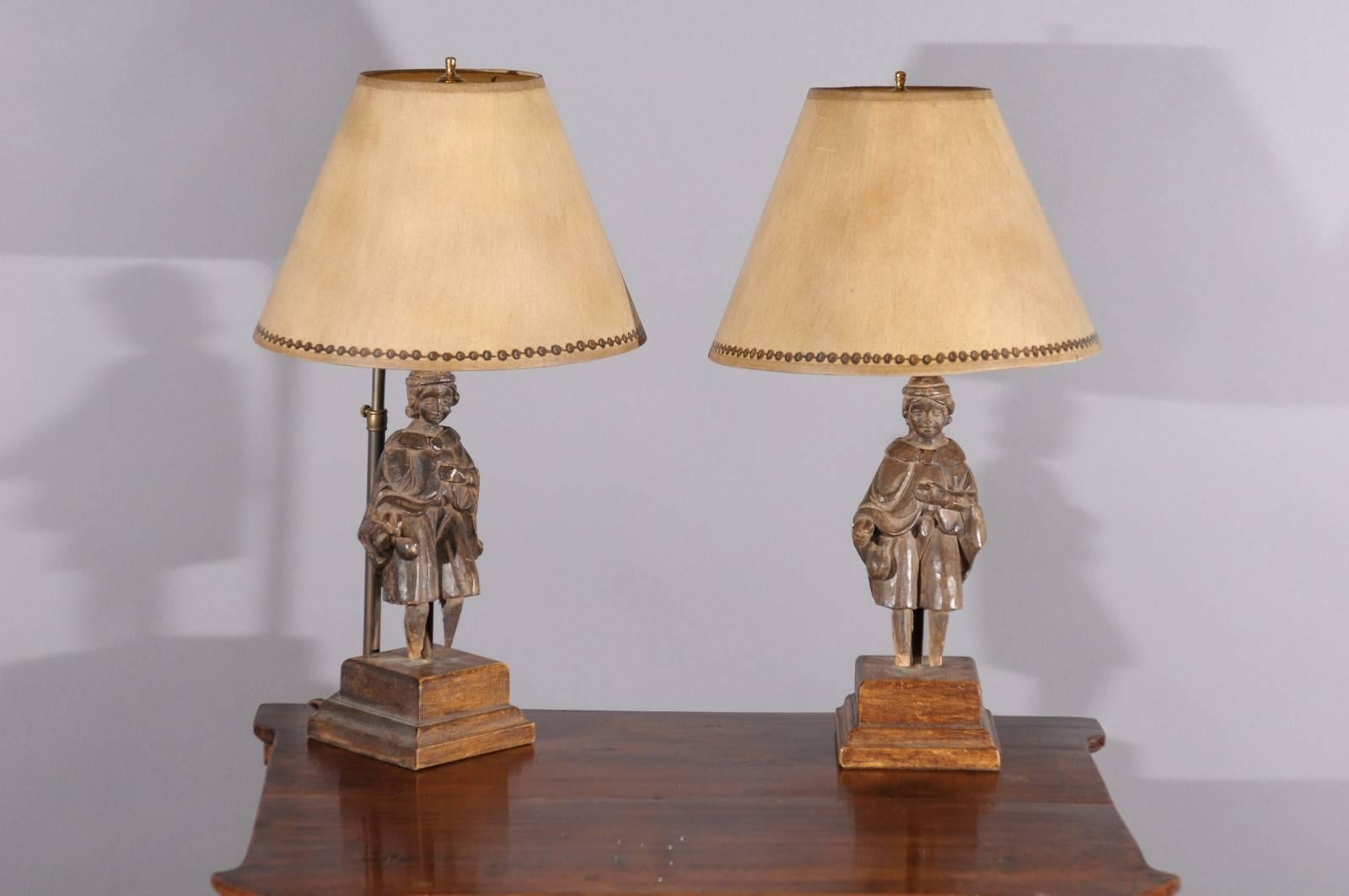 Pair of carved oak 19th century figural fragments mounted as table lamps with shades.