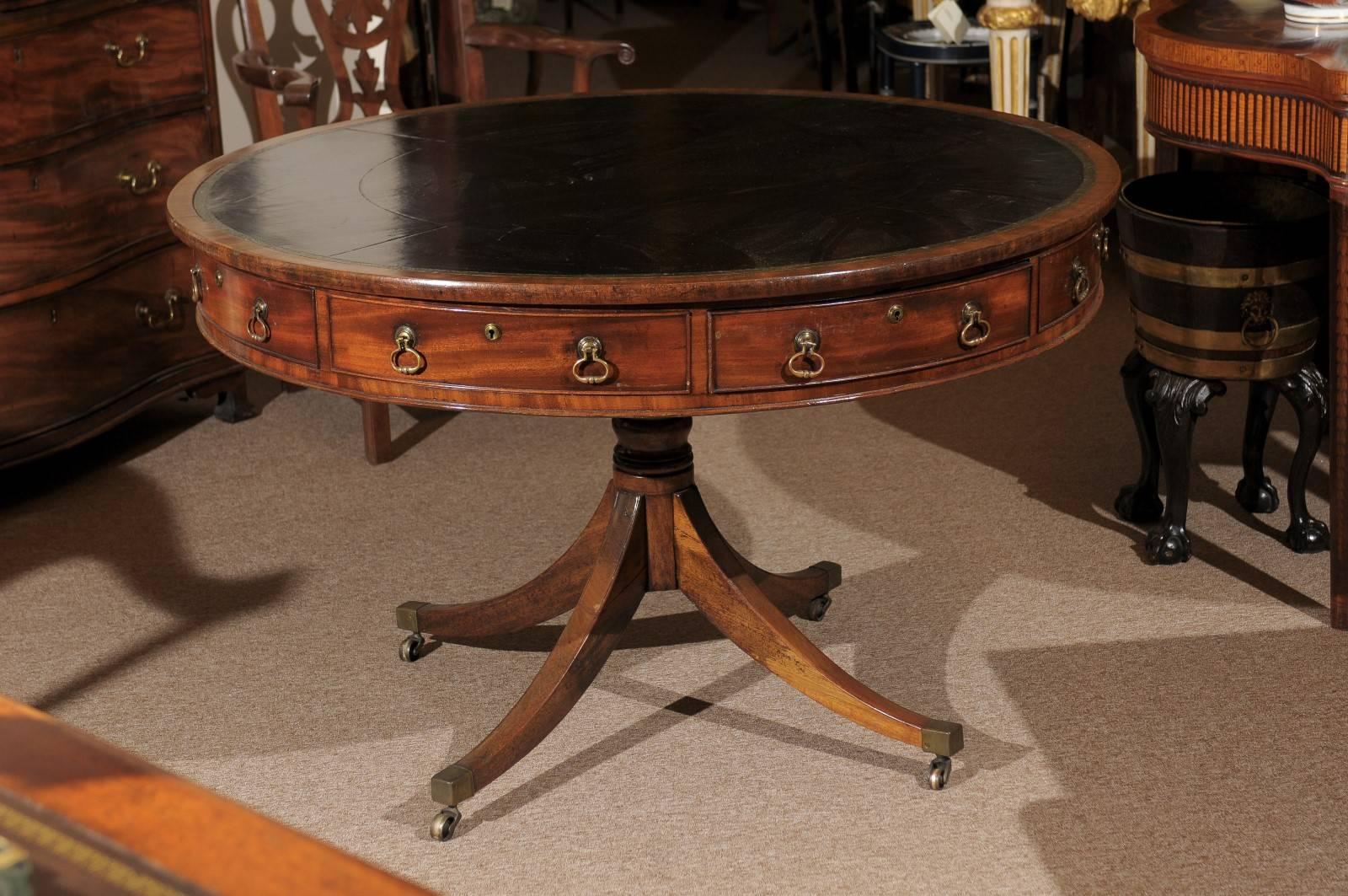 19th century English mahogany rent table with dark green leather top and four sliding drawers.

