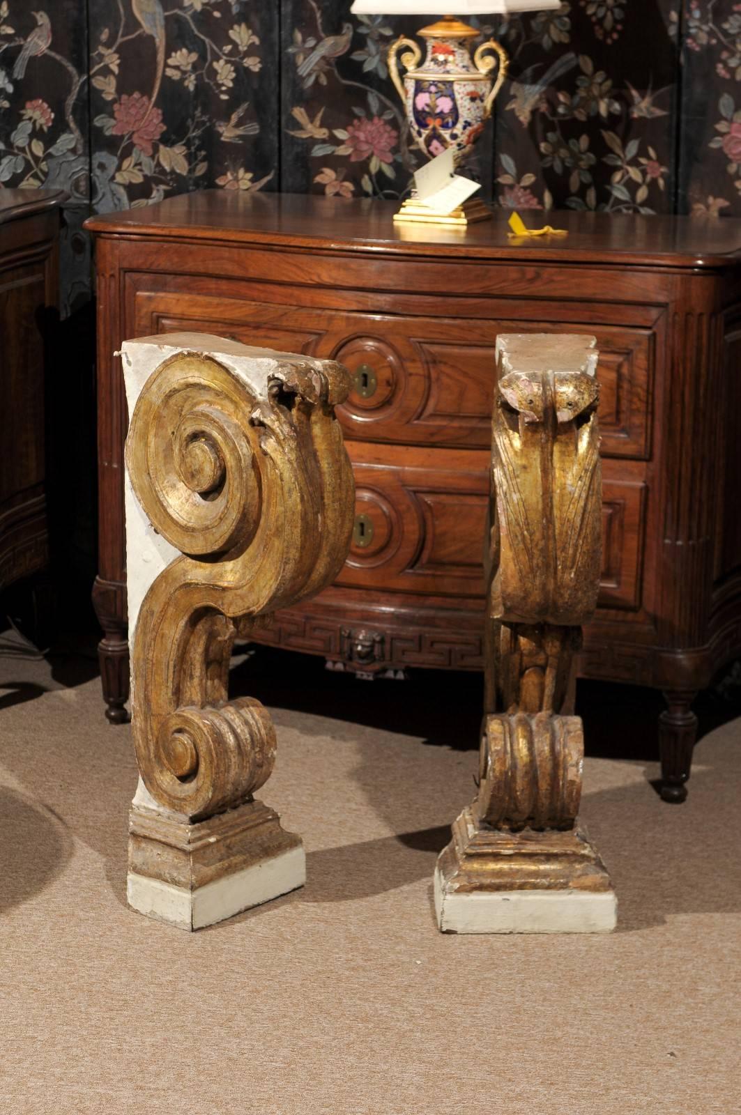 Pair of large painted and parcel-gilt brackets with carved acanthus leaf and scroll detail.