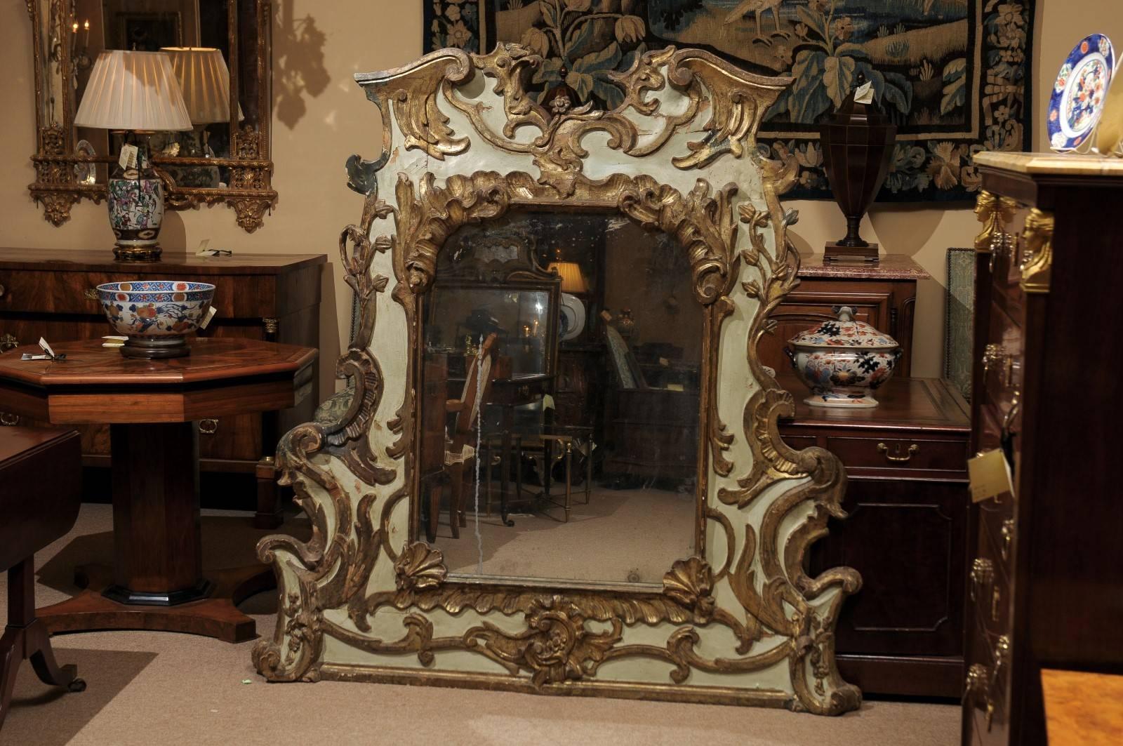 Large and unusual, intricately carved painted and parcel-gilt mirror, 18th Century Italy (Venice), green painted hue