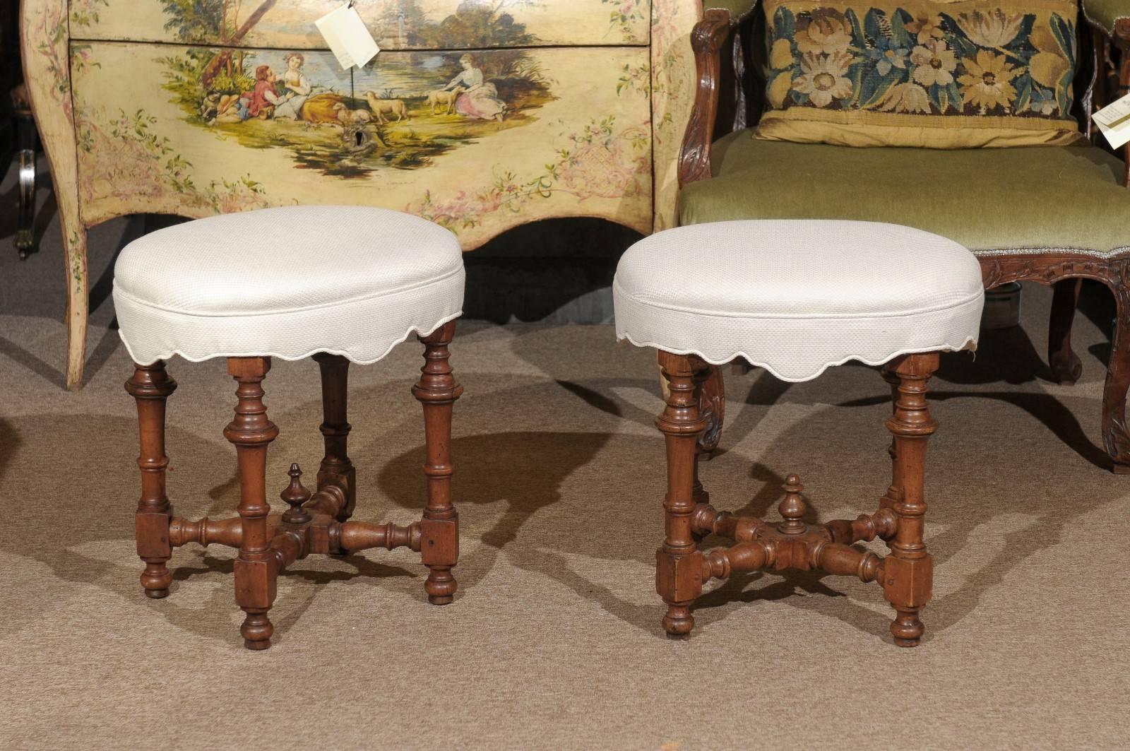 Pair of 18th century Italian turned leg oval benches in walnut.