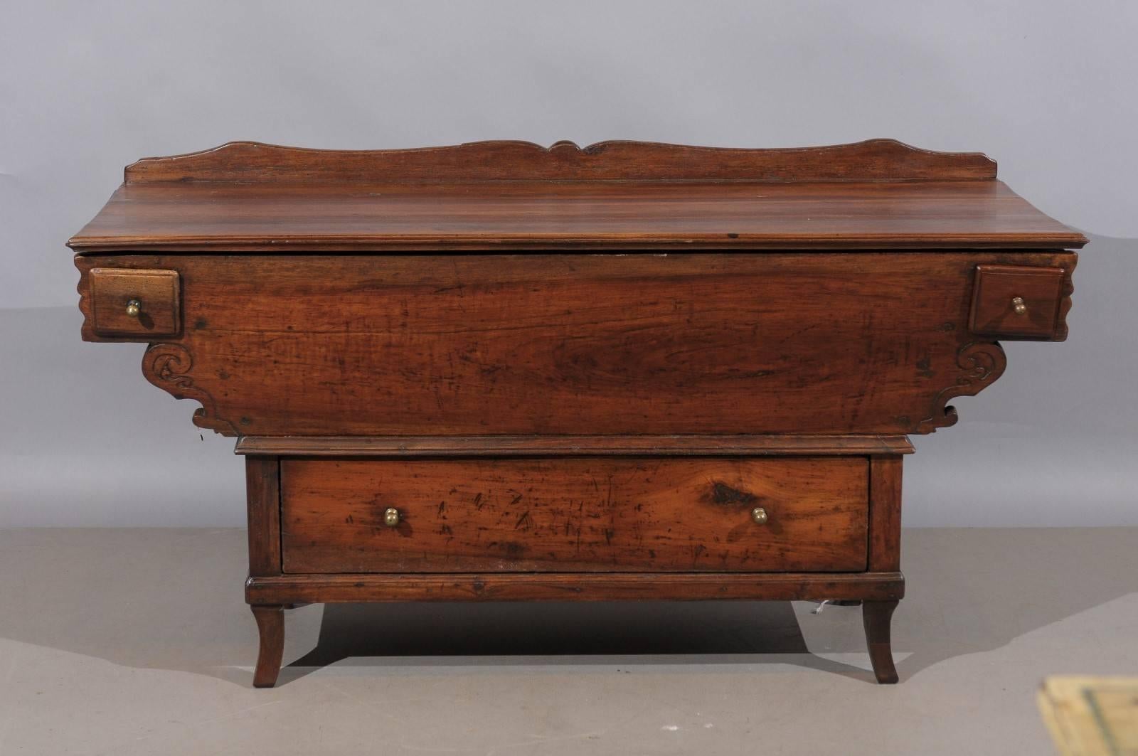 Long rustic walnut and elm dough bin, Switzerland 18th century. It has a lift top, two (2) small side drawers and one (1) large lower drawer.