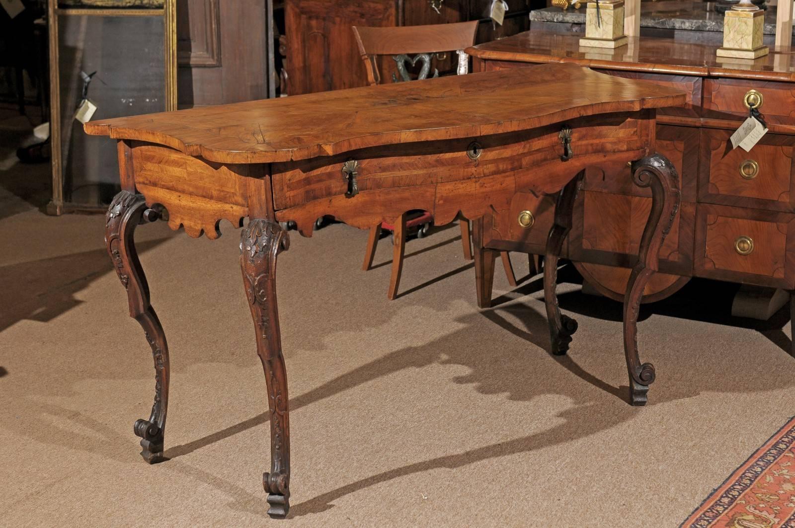 Large Rococo period console table in walnut with serpentine top, carved legs and apron, and one (1) Drawer, 18th century, Italy.