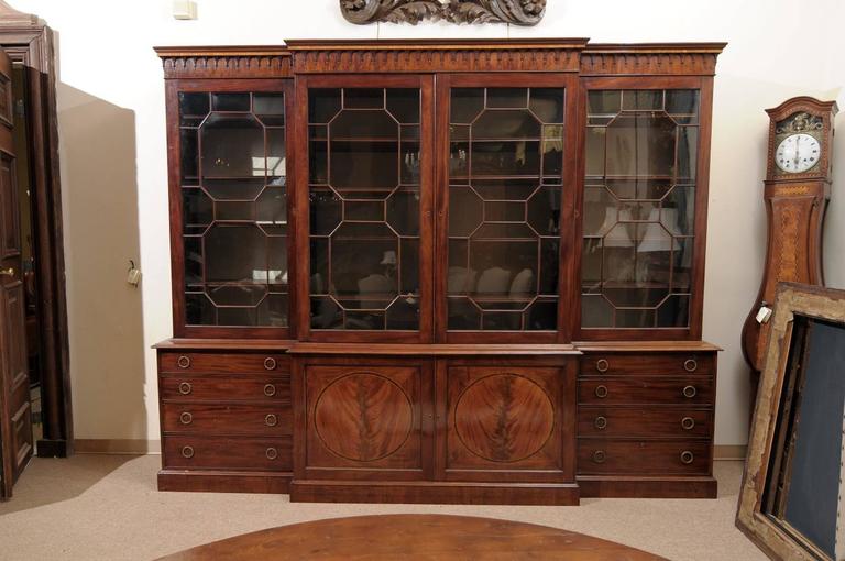 Large Late 18th Century English George III Mahogany Breakfront Bookcase with 4 Glass Cabinet Doors above 2 Cabinet Doors and 8 Drawers.