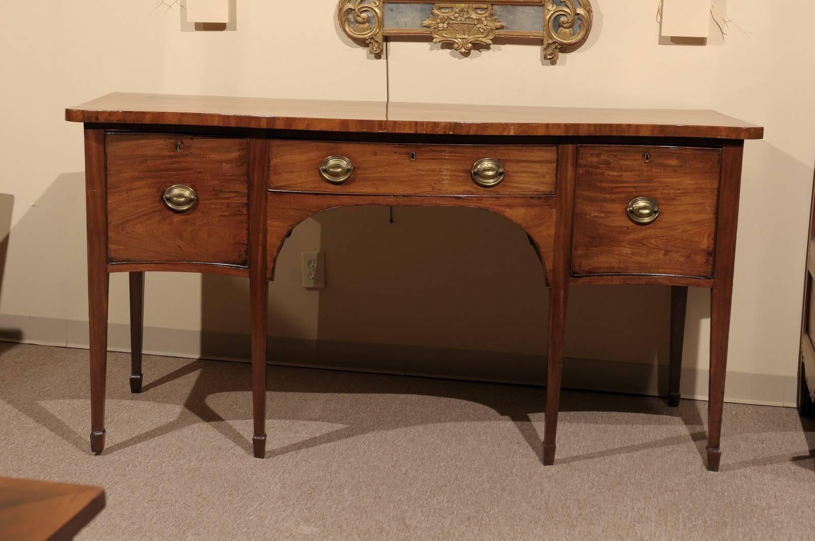 English George III mahogany sideboard with spade feet and serpentine front, circa 1790.