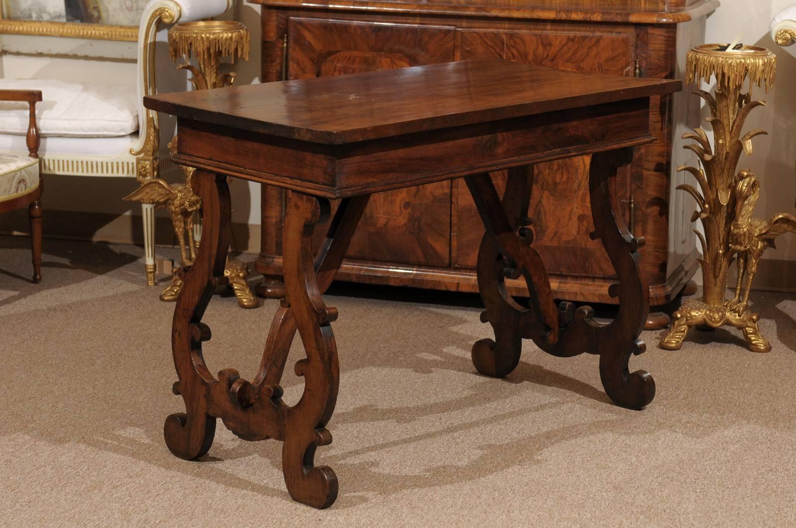 A 18th century Italian walnut console table with lyre formed legs.