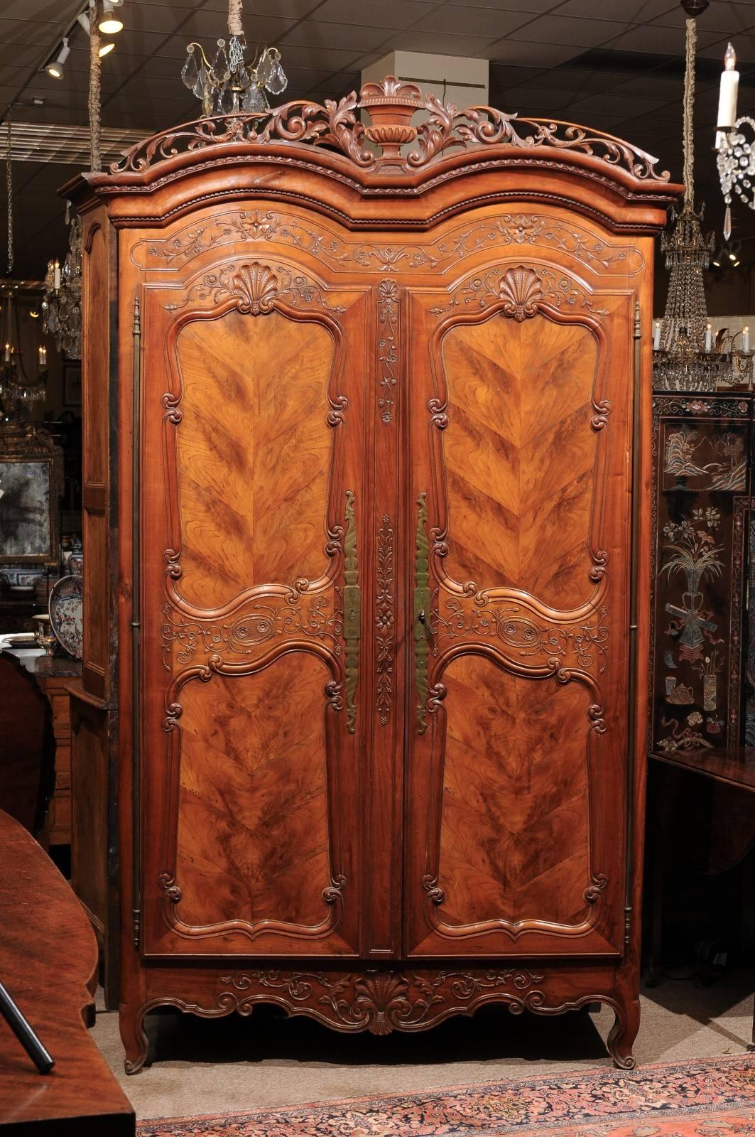 Fruitwood armoire in the Renaissance style with double bonnet top and carved apron, France 19th century.
