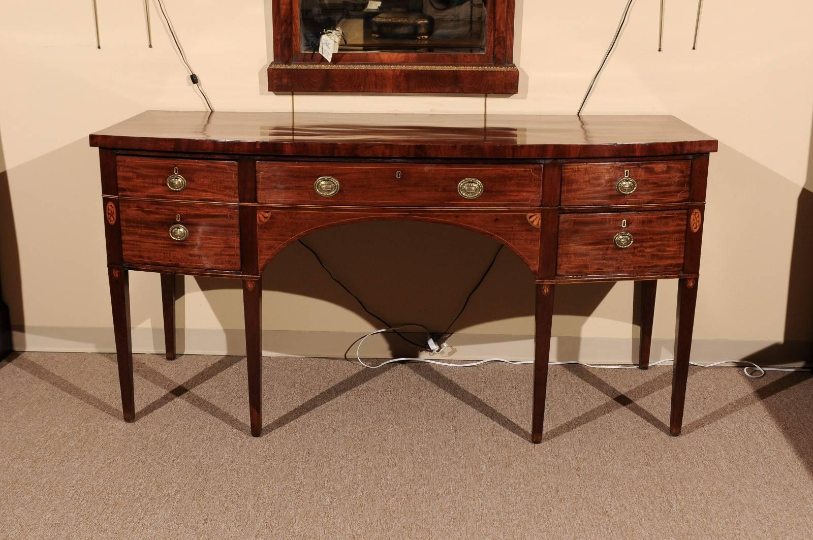 Early 19th century English mahogany sideboard with bow-front, marquetry inlay and square tapering legs.