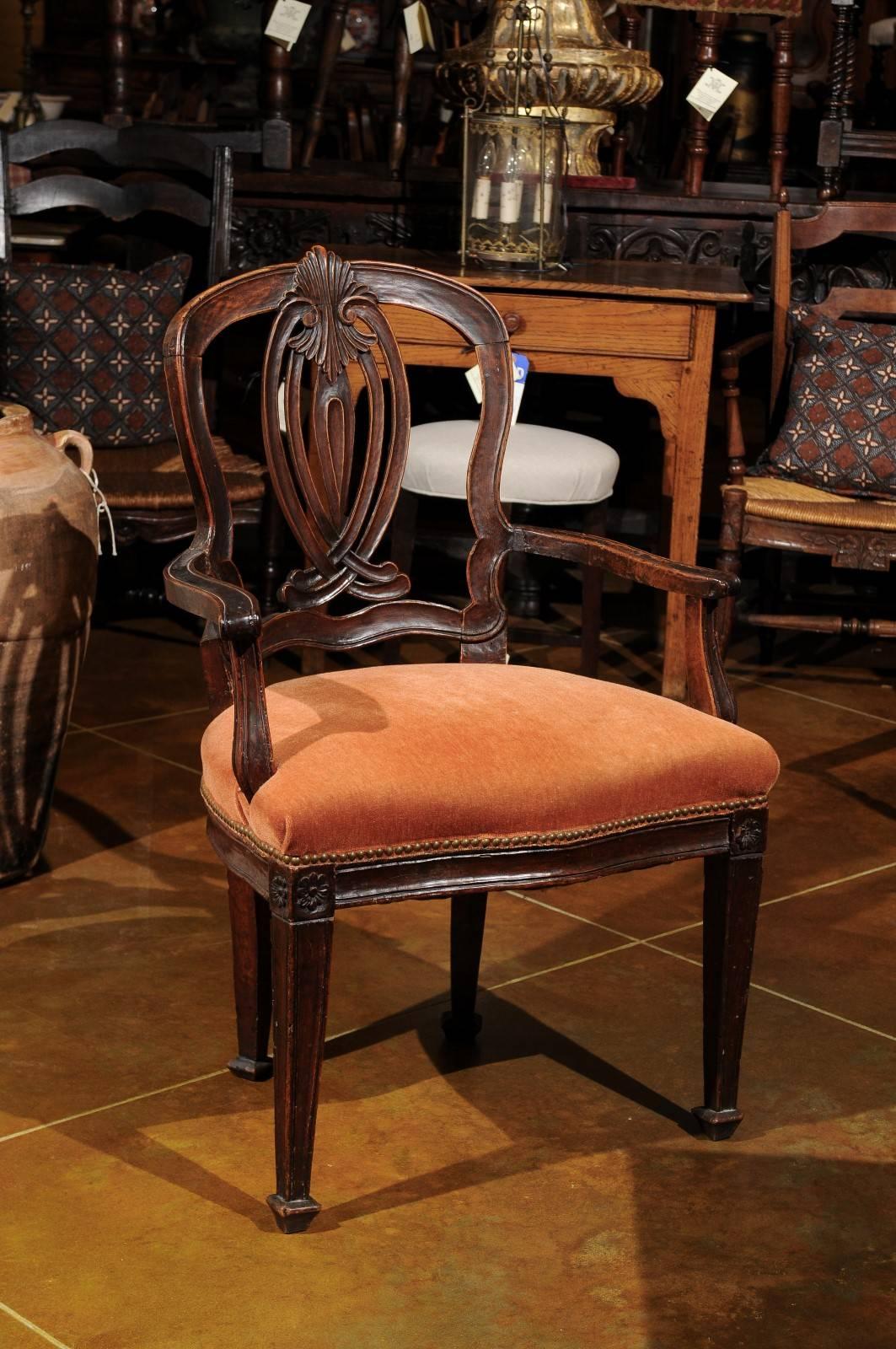 Italian walnut arm chair transitioning from Rococo to neoclassical styles on tapered legs, circa 1780.