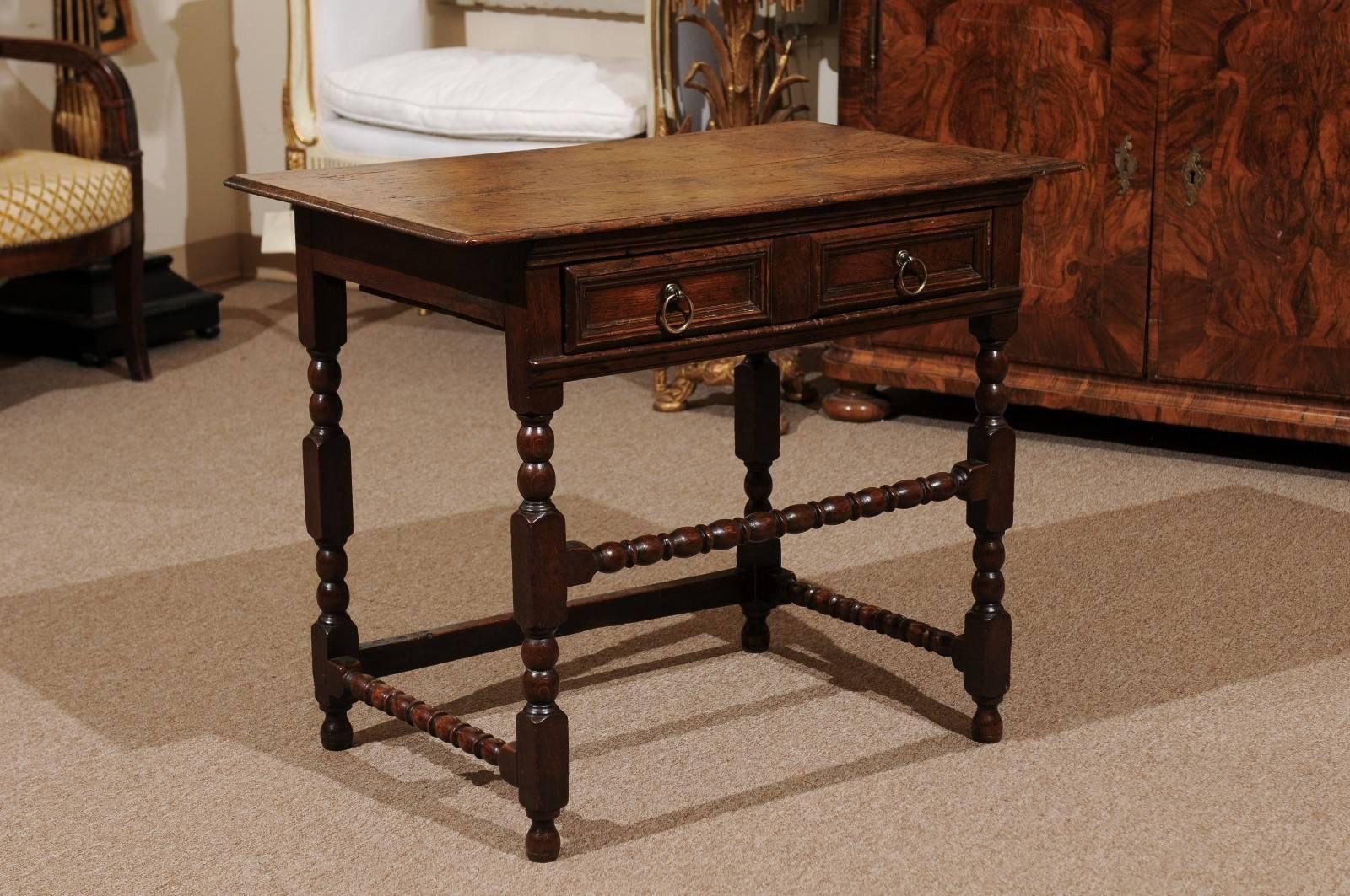 Side table in oak with one-drawer and bobbin turned legs and stretcher, England, 19th century.