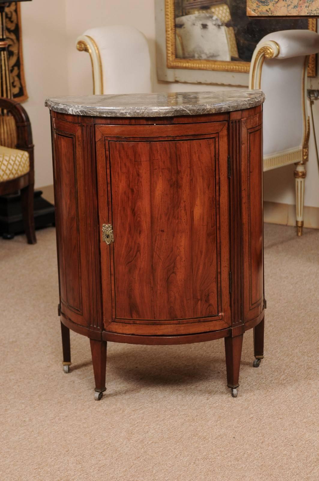 Petite 18th century French Louis XVI period demilune cabinet in walnut with inlay and fluted detail, grey marble top.